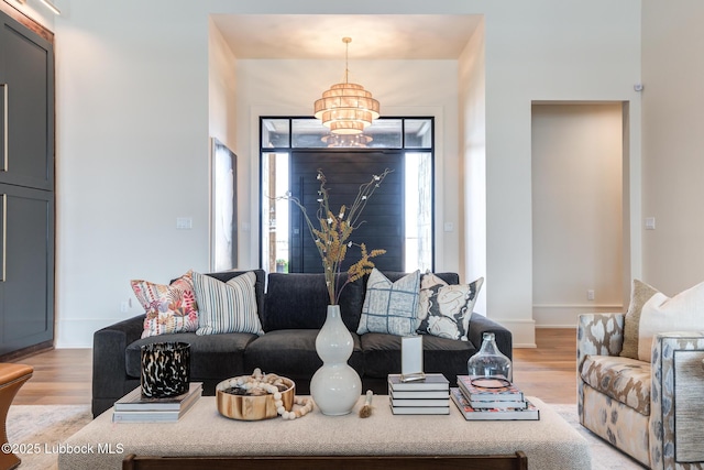 4510 Zadar Ave, Lubbock, TX 79407 - living room featuring a chandelier and light wood-style flooring