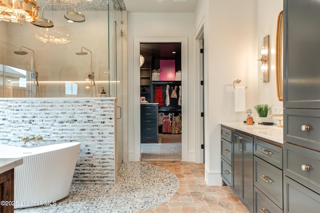 4510 Zadar Ave, Lubbock, TX 79407 - bathroom featuring vanity, a stall shower, a chandelier, and a walk in closet