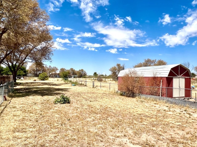 view of yard featuring an outbuilding and a rural view