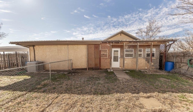 back of house featuring central AC unit