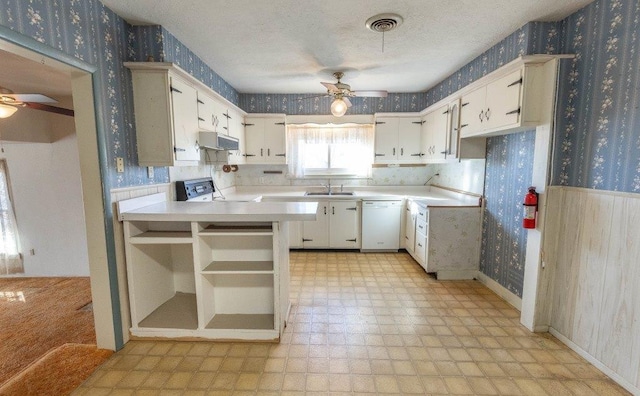 kitchen with white cabinetry, dishwasher, ceiling fan, and kitchen peninsula