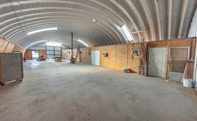 misc room with vaulted ceiling and concrete floors