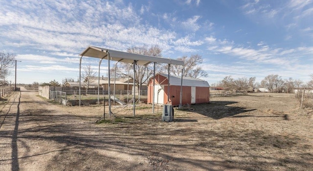 view of yard featuring a rural view and a storage shed