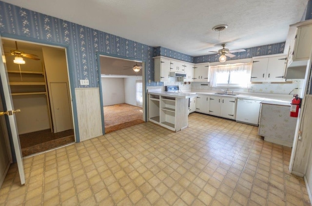 kitchen featuring dishwasher, sink, white cabinets, ceiling fan, and kitchen peninsula