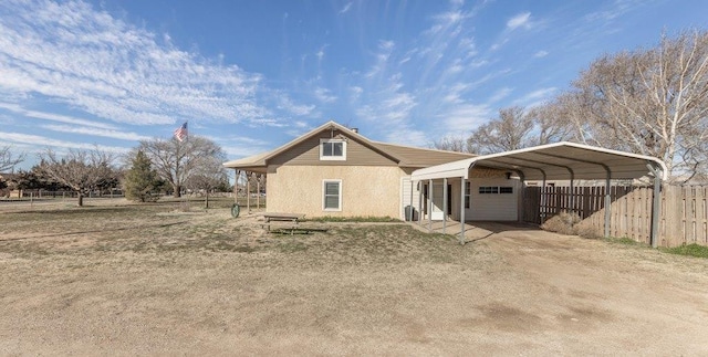 back of house featuring a carport and a garage