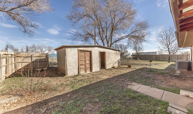 view of yard with a storage shed and central AC