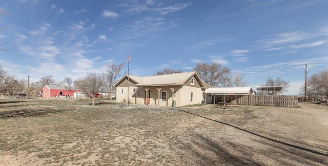 back of property featuring a carport