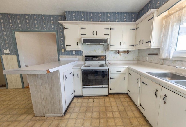 kitchen featuring white electric stove, kitchen peninsula, sink, and white cabinets