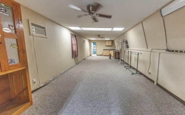 hallway with light colored carpet and a wall unit AC