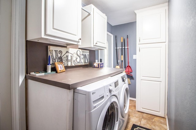 clothes washing area featuring cabinets, washer and dryer, and light tile patterned floors