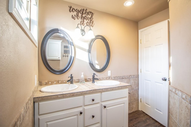 bathroom with vanity, wood-type flooring, and tile walls