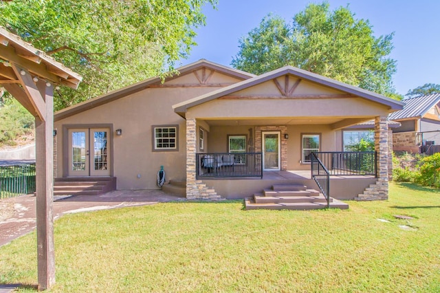 view of front of property with covered porch and a front lawn