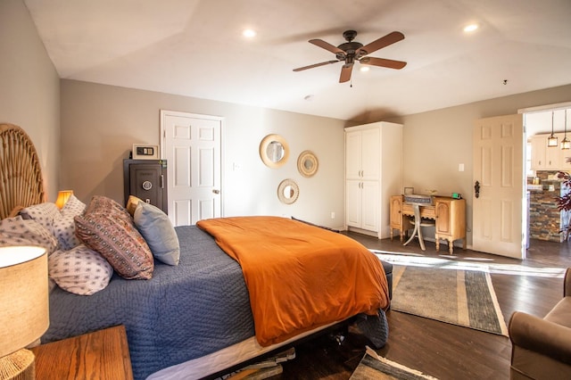 bedroom featuring ceiling fan, lofted ceiling, and dark hardwood / wood-style flooring