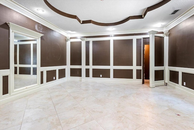 unfurnished room with ornate columns, crown molding, light tile patterned flooring, and a textured ceiling