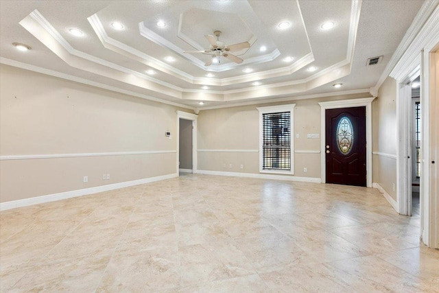 entrance foyer featuring crown molding, ceiling fan, and a raised ceiling