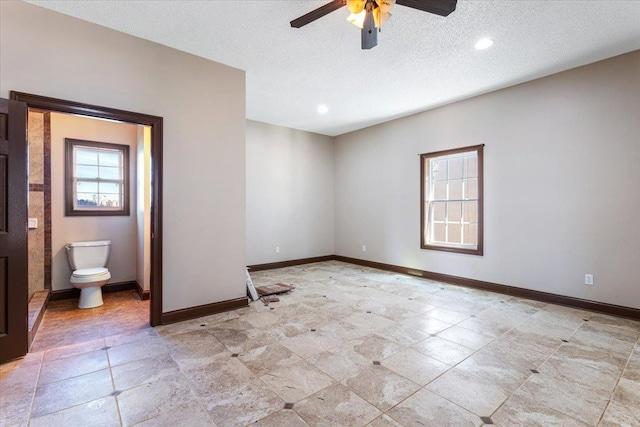 empty room featuring ceiling fan and a textured ceiling