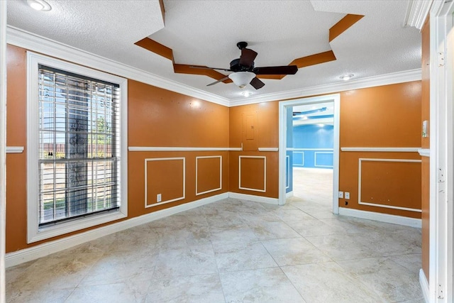 spare room featuring crown molding, ceiling fan, and a textured ceiling