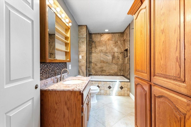 full bathroom featuring backsplash, vanity, tile patterned floors, toilet, and tiled shower / bath