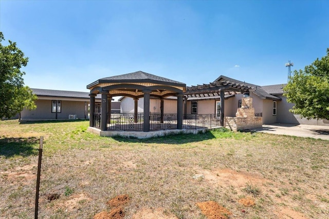 back of house with a pergola, a yard, and a gazebo