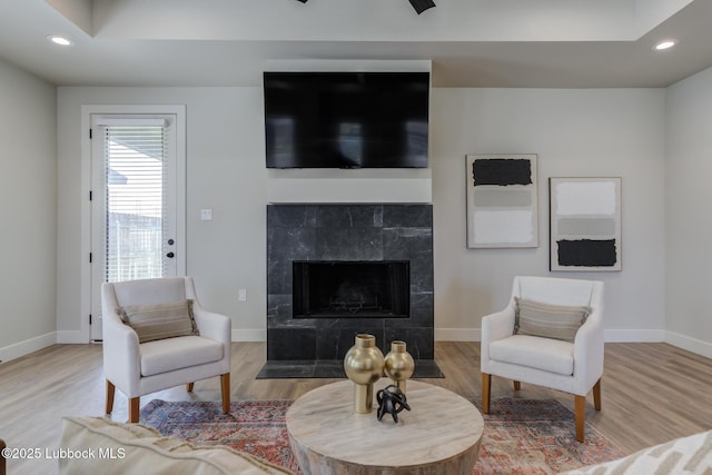 5713 119th St, Lubbock, TX 79424 - living room featuring wood finished floors, recessed lighting, a tile fireplace, and baseboards