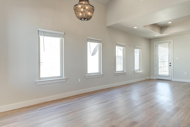 5713 119th St, Lubbock, TX 79424 - empty room featuring baseboards, light wood finished floors, a chandelier, and recessed lighting
