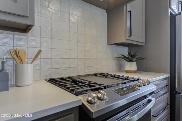 5713 119th St, Lubbock, TX 79424 - kitchen with gas stove, gray cabinets, light countertops, and tasteful backsplash
