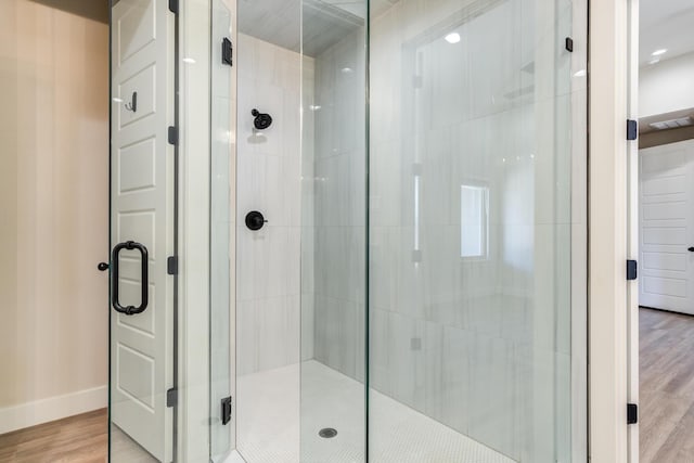 5713 119th St, Lubbock, TX 79424 - full bath with a stall shower, wood finished floors, and baseboards