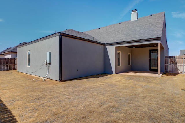 5713 119th St, Lubbock, TX 79424 - back of house featuring a patio area, stucco siding, roof with shingles, and a chimney