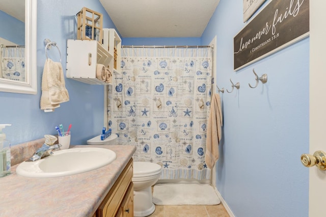 bathroom with vanity, tile patterned floors, and toilet