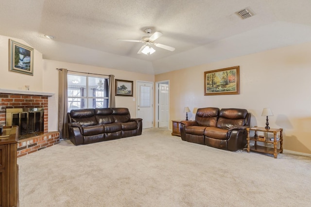 living room with lofted ceiling, light carpet, a fireplace, and ceiling fan