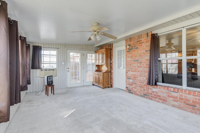 unfurnished living room with light carpet and ceiling fan