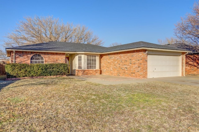 ranch-style home featuring a garage and a front lawn