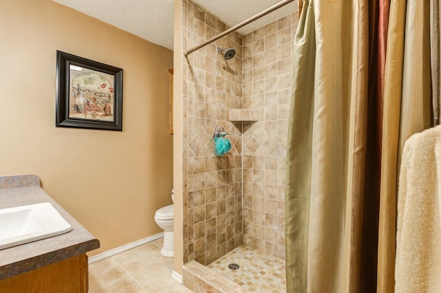 bathroom featuring tile patterned floors, toilet, a shower with curtain, a textured ceiling, and vanity