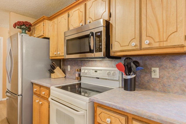 kitchen with stainless steel appliances, decorative backsplash, and a textured ceiling