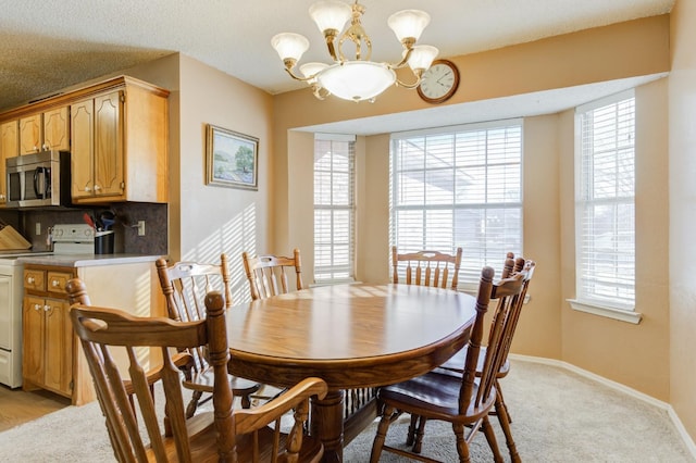 dining room featuring light carpet and an inviting chandelier