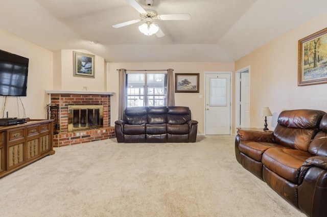 living room with lofted ceiling, carpet floors, ceiling fan, and a brick fireplace