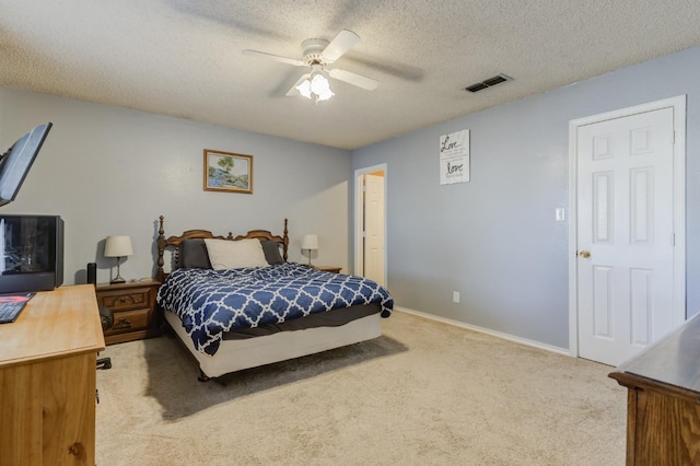 carpeted bedroom featuring a textured ceiling and ceiling fan