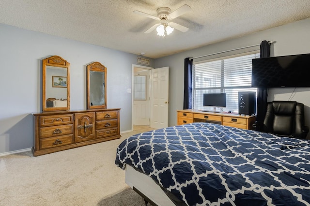 bedroom with ceiling fan, carpet floors, and a textured ceiling