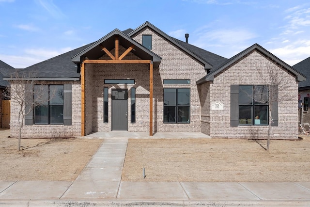 view of front of house featuring brick siding
