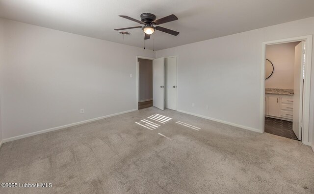 3410 53rd St, Lubbock, TX 79413 - unfurnished bedroom featuring carpet floors, connected bathroom, and ceiling fan