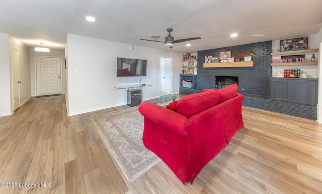 3410 53rd St, Lubbock, TX 79413 - living room with ceiling fan, a fireplace, light wood-type flooring, and recessed lighting