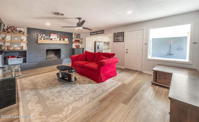 3410 53rd St, Lubbock, TX 79413 - living room with wood finished floors, a fireplace, ceiling fan, and recessed lighting
