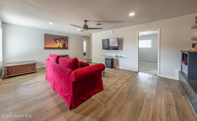 3410 53rd St, Lubbock, TX 79413 - living room with a fireplace, wood finished floors, ceiling fan, and recessed lighting