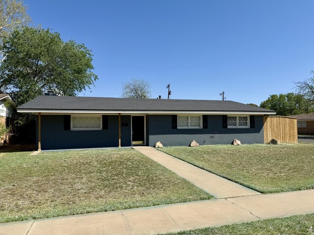 3410 53rd St, Lubbock, TX 79413 - ranch-style home with a front lawn and brick siding