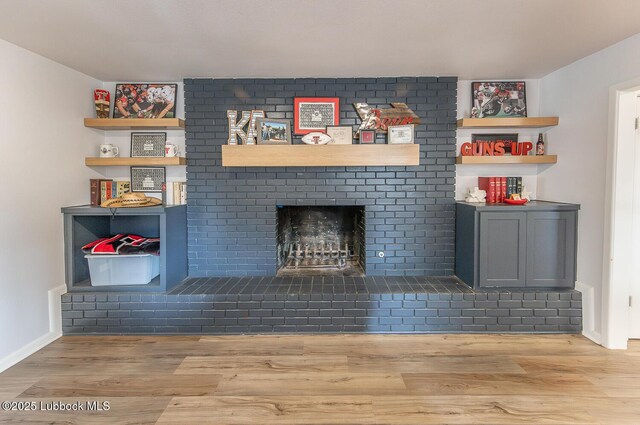 3410 53rd St, Lubbock, TX 79413 - unfurnished living room featuring a brick fireplace and wood finished floors