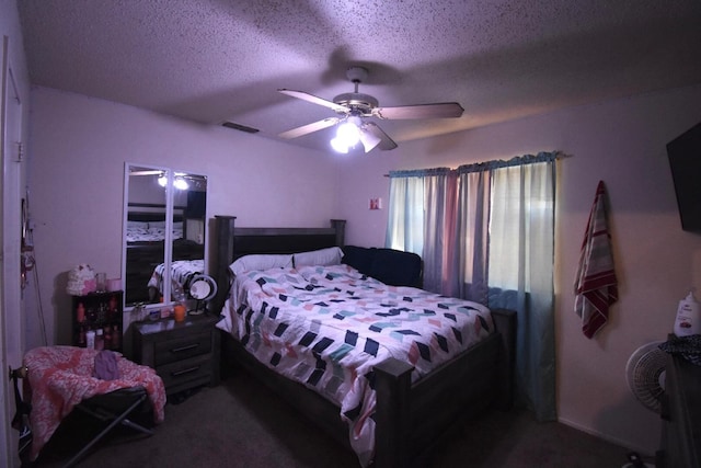 carpeted bedroom with ceiling fan and a textured ceiling