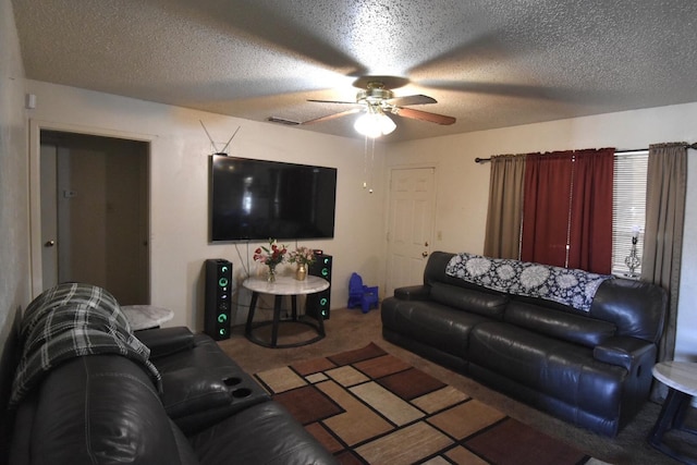 living room with carpet, a textured ceiling, and ceiling fan