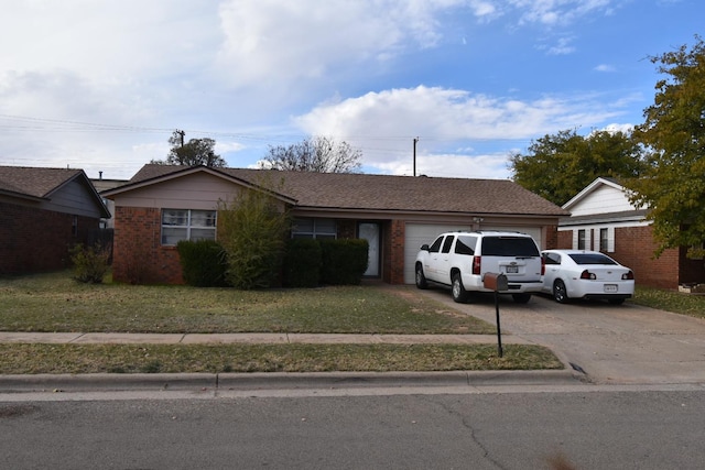 ranch-style house featuring a garage and a front lawn