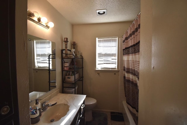 full bathroom featuring vanity, a healthy amount of sunlight, shower / bath combo, and a textured ceiling