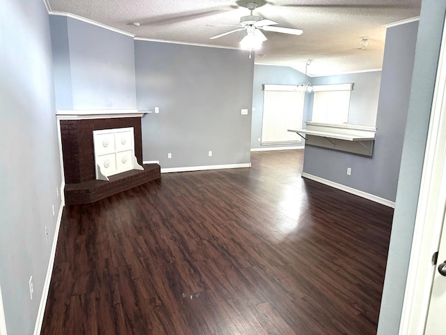 unfurnished living room featuring dark hardwood / wood-style flooring, crown molding, and a textured ceiling